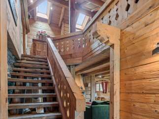 Step into rustic elegance with this stunning wooden staircase.