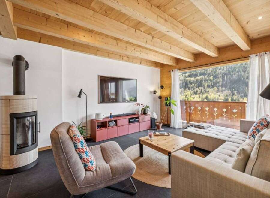 Experience the charm of this stunning living space, featuring a cozy fireplace and a modern entertainment setup.