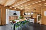 Experience the warmth of this stunning dining room, featuring a beautiful wooden ceiling and walls that create a cozy atmosphere.