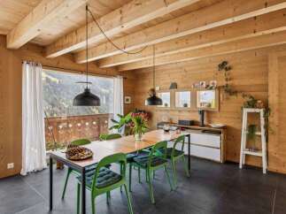 Experience the warmth of this stunning dining room, featuring a beautiful wooden ceiling and walls that create a cozy atmosphere.