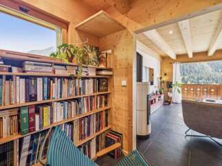 This cozy cabin boasts a stunning view and a warm, inviting interior.