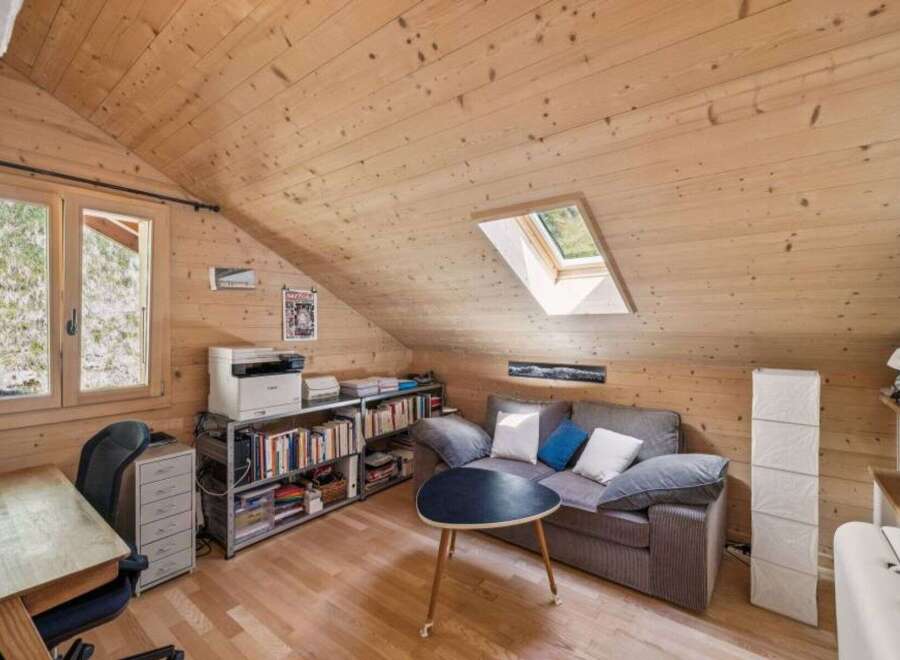 Discover the charm of this cozy attic space, perfect for a home office or a relaxing retreat.
