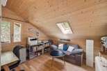 Discover the charm of this cozy attic space, perfect for a home office or a relaxing retreat.