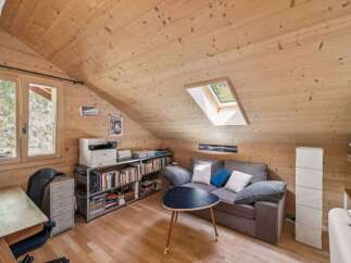 Discover the charm of this cozy attic space, perfect for a home office or a relaxing retreat.