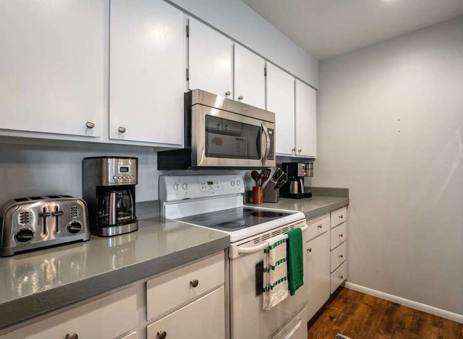 This charming kitchen boasts a modern design with sleek countertops and ample cabinet space.