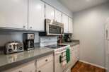 This charming kitchen boasts a modern design with sleek countertops and ample cabinet space.