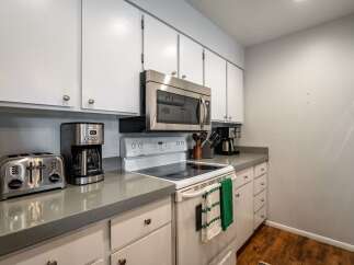 This charming kitchen boasts a modern design with sleek countertops and ample cabinet space.