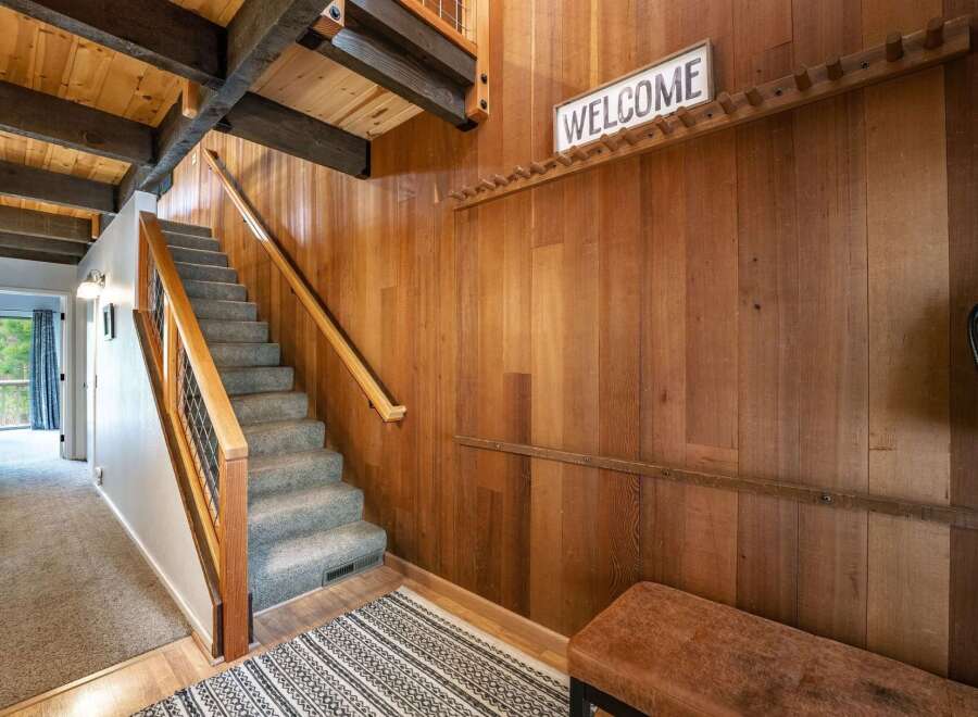 Step into this inviting home and be greeted by a stunning staircase and warm wooden accents.