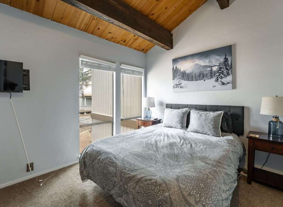 This cozy bedroom features a comfortable bed with stylish bedding, perfect for a relaxing retreat.