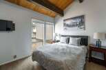 This cozy bedroom features a comfortable bed with stylish bedding, perfect for a relaxing retreat.