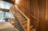 This stunning property boasts a beautifully crafted staircase with a modern design, featuring wooden steps and a sleek metal railing.