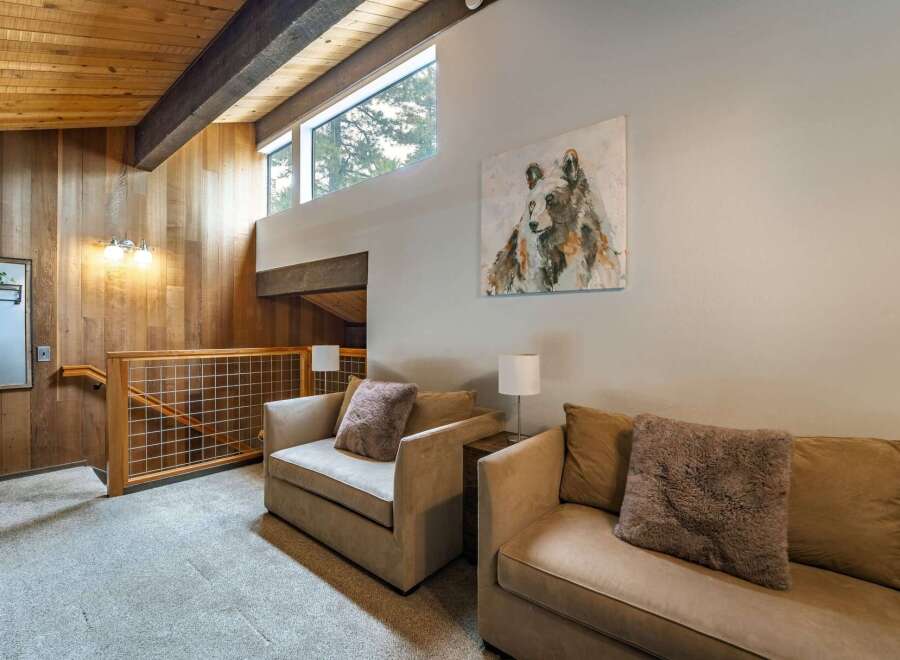 Discover the charm of this stunning property, featuring a cozy living area with comfortable seating and a captivating bear artwork.