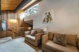 Discover the charm of this stunning property, featuring a cozy living area with comfortable seating and a captivating bear artwork.