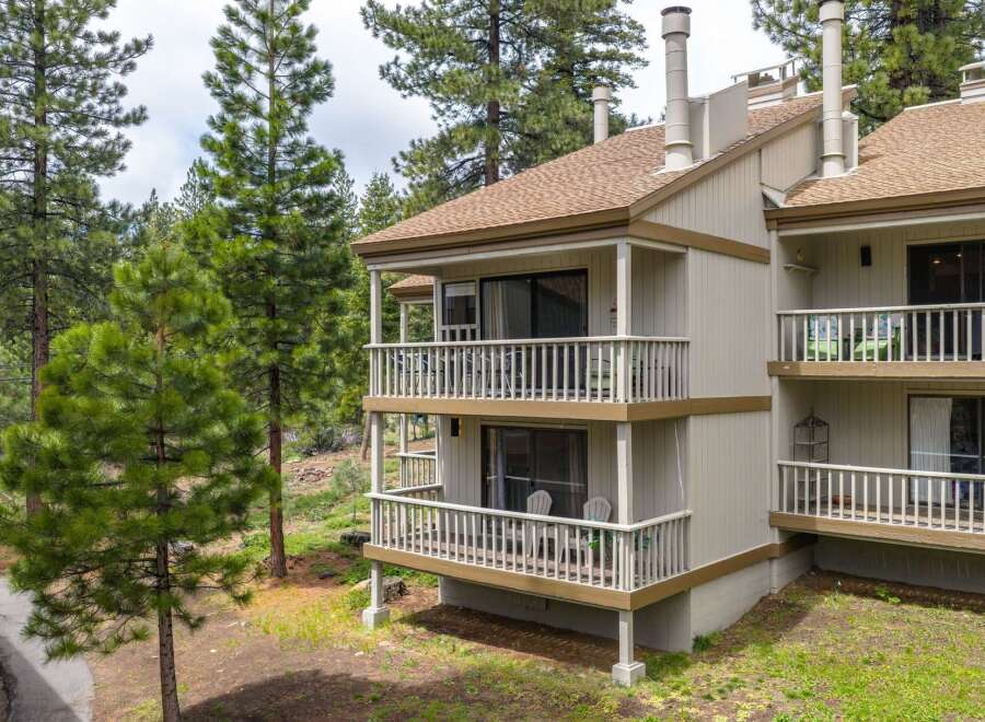 Discover a charming two-story condo nestled amidst lush greenery.