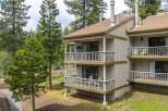 Discover a charming two-story condo nestled amidst lush greenery.