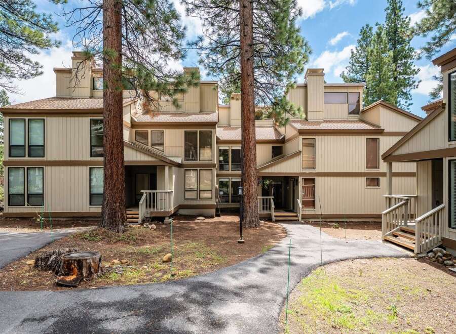 Discover a charming townhouse nestled in a serene, tree-lined setting.