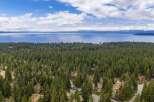 Discover a stunning property nestled amidst a lush forest with breathtaking lake views.