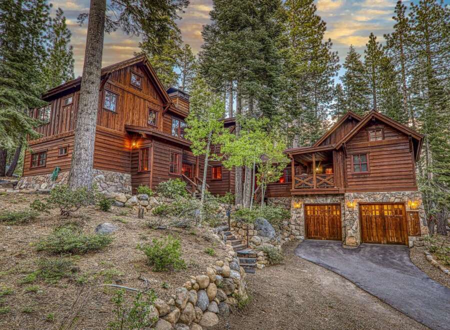 Nestled amidst towering trees, this stunning wooden cabin offers a serene escape.