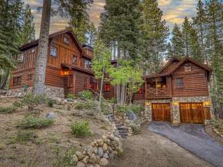 Nestled amidst towering trees, this stunning wooden cabin offers a serene escape.