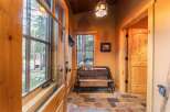 Step into this inviting entryway, showcasing a rustic bench and a welcoming 'Welcome' sign.