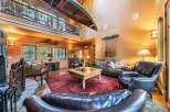 Step into rustic luxury with this stunning property, featuring a unique canoe suspended from the ceiling and a cozy fireplace.