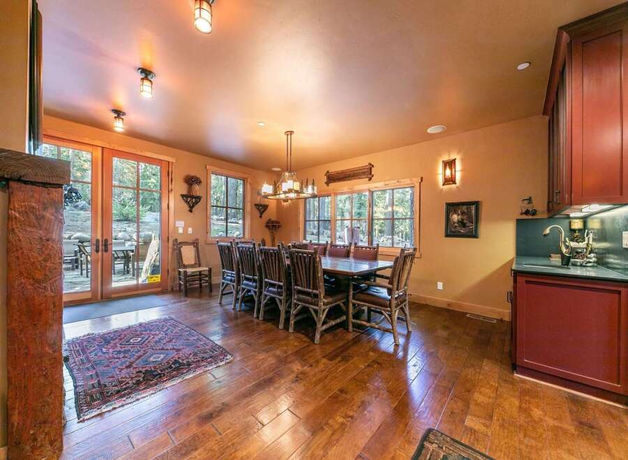 Step into luxury with this stunning dining room, featuring a rustic wooden table and chairs, perfect for hosting gatherings.