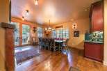 Step into luxury with this stunning dining room, featuring a rustic wooden table and chairs, perfect for hosting gatherings.