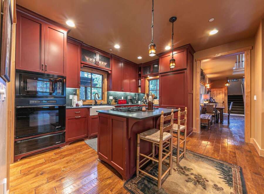 This stunning kitchen boasts rich, warm tones and a functional layout, perfect for both cooking and entertaining.