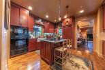 This stunning kitchen boasts rich, warm tones and a functional layout, perfect for both cooking and entertaining.