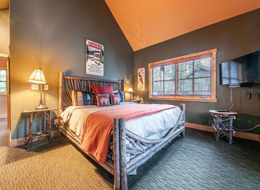 Experience rustic charm in this cozy bedroom, perfect for a relaxing getaway.