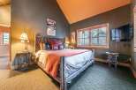 Experience rustic charm in this cozy bedroom, perfect for a relaxing getaway.