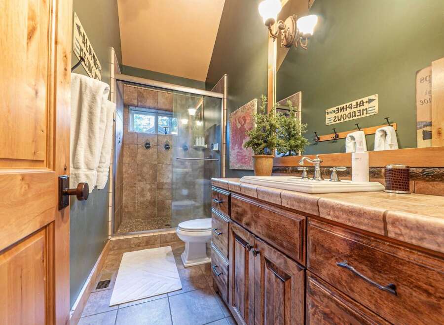 Step into this beautifully designed bathroom, featuring a spacious glass-enclosed shower and a stylish vanity with ample storage.