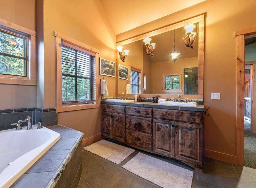 Step into luxury with this stunning bathroom! Featuring a spacious vanity with ample storage, a relaxing bathtub, and natural light, this space is perfect for unwinding.