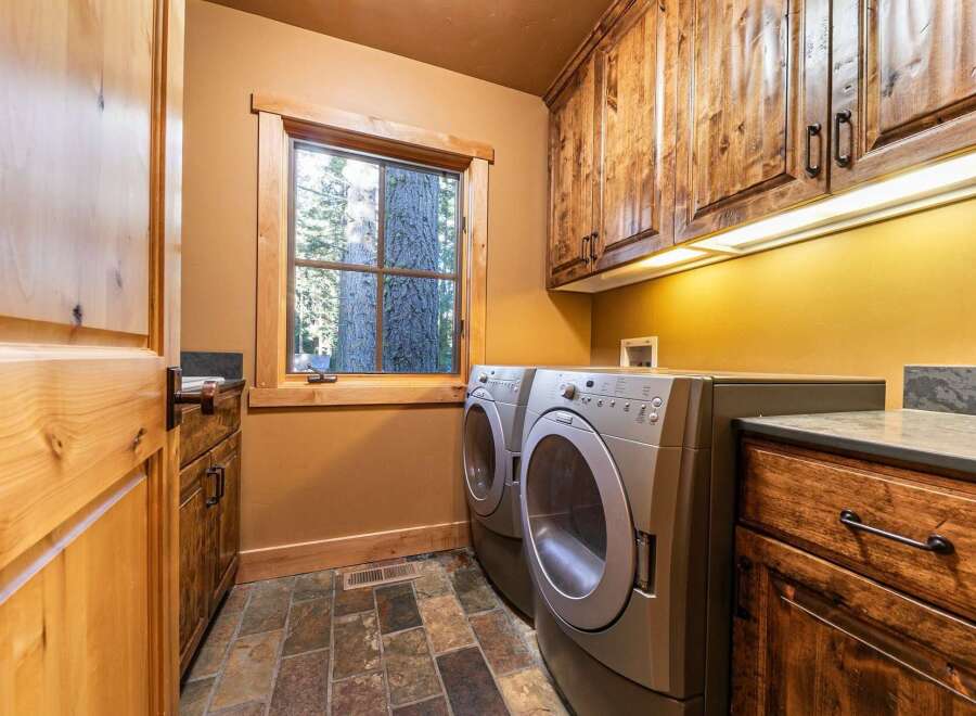 Step into this beautifully designed laundry room, featuring a modern washer and dryer set.