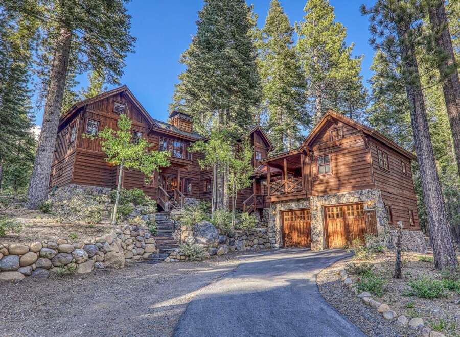 Nestled amidst towering trees, this stunning wooden cabin offers a serene retreat.