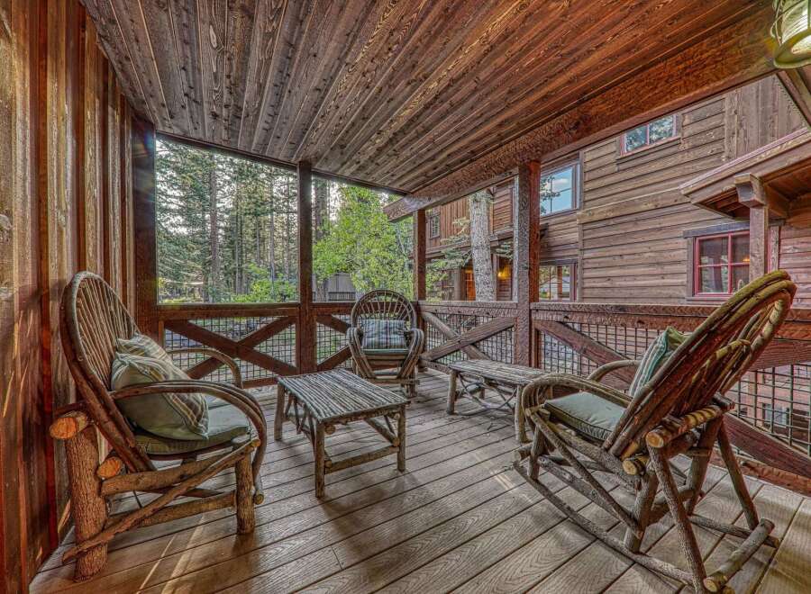 Enjoy the tranquility of this stunning cabin porch, perfect for relaxing and taking in the natural beauty.