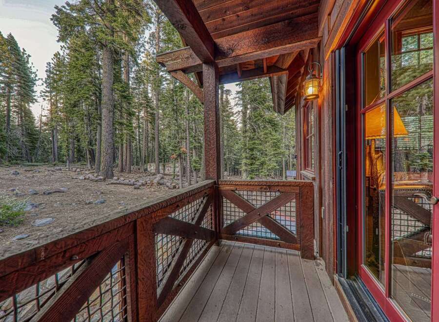 Step into a world of rustic charm with this stunning property, featuring a beautifully crafted wooden porch.