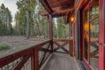 Step into a world of rustic charm with this stunning property, featuring a beautifully crafted wooden porch.