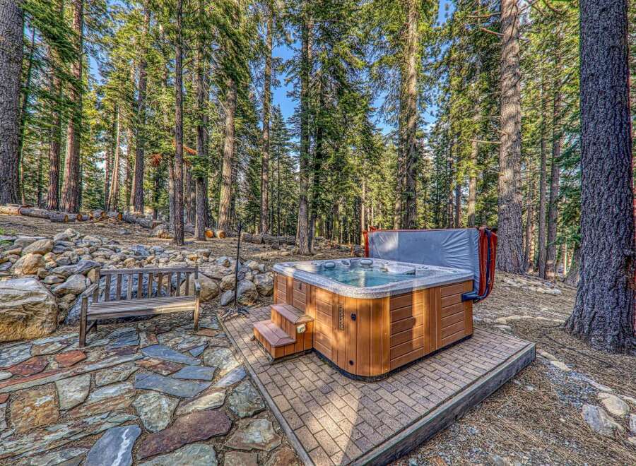 Escape to your own private oasis with this stunning property featuring a luxurious hot tub nestled amidst a serene forest setting.
