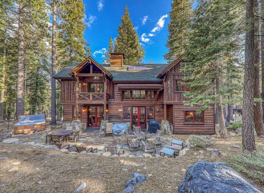 Escape to your dream mountain retreat! This stunning cabin boasts a rustic charm with its wooden exterior and inviting outdoor spaces.