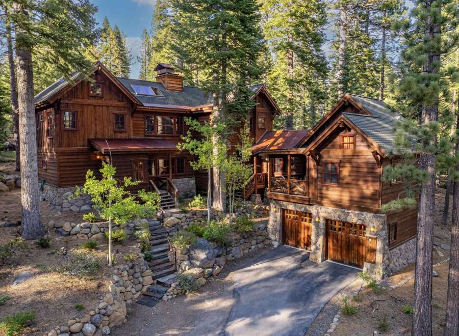 Nestled amidst towering trees, this stunning wooden cabin offers a serene retreat.