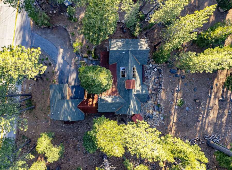 Nestled amidst towering trees, this stunning property offers a serene escape.