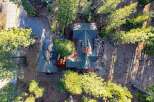 Nestled amidst towering trees, this stunning property offers a serene escape.