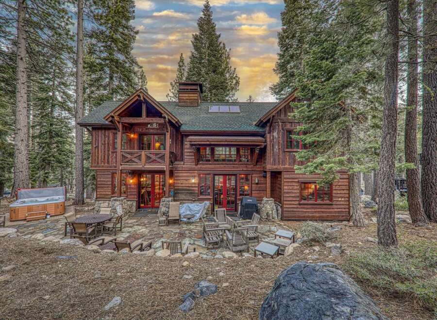 Nestled amidst towering trees, this stunning log cabin offers a serene retreat.