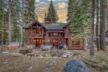 Nestled amidst towering trees, this stunning log cabin offers a serene retreat.