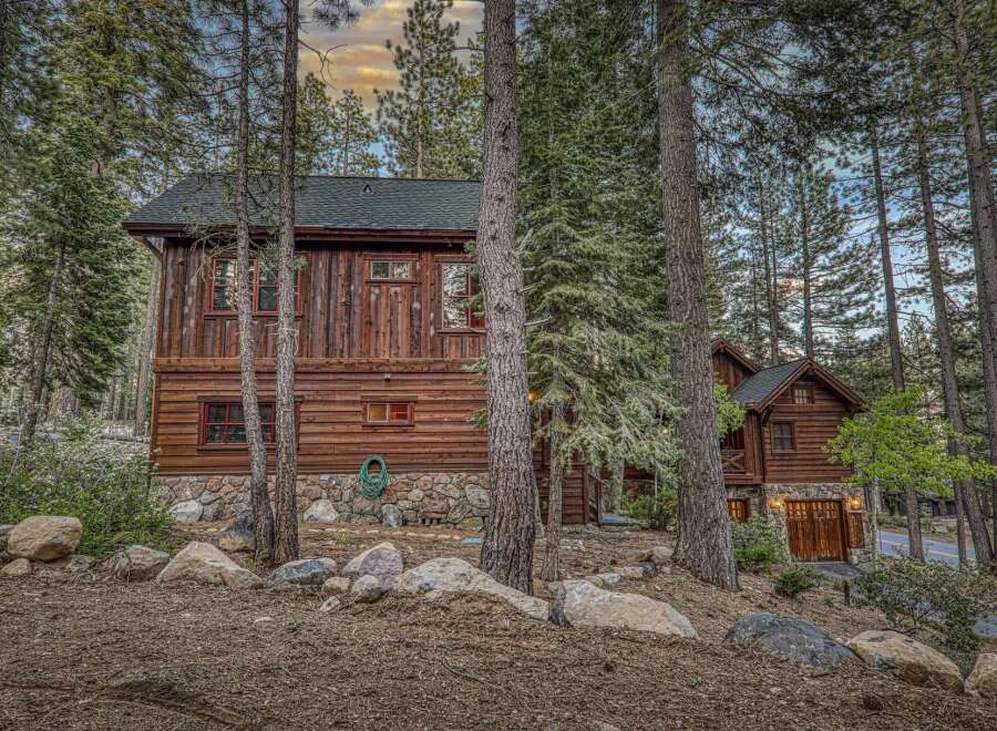 Nestled amidst towering trees, this stunning cabin offers a serene escape.