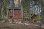 Nestled amidst towering trees, this stunning cabin offers a serene escape.