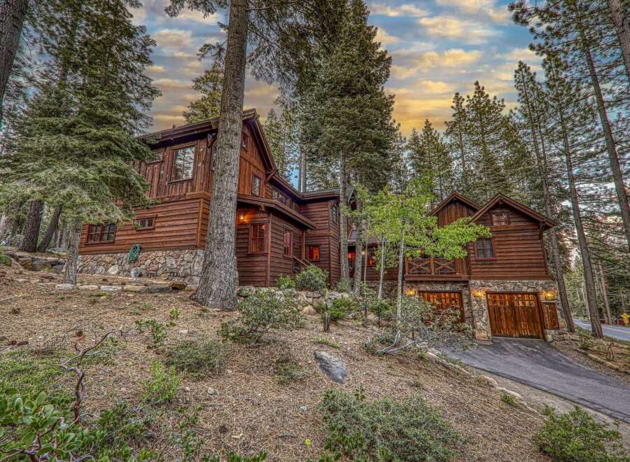 Nestled amidst towering trees, this stunning wooden cabin offers a serene retreat.