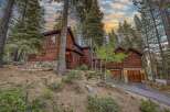 Nestled amidst towering trees, this stunning wooden cabin offers a serene retreat.