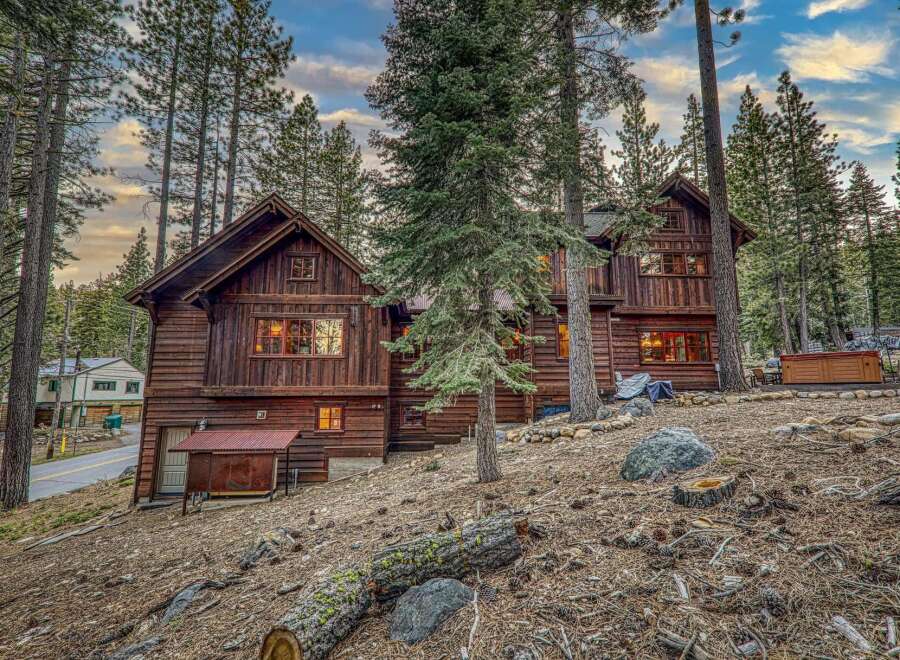 Nestled amidst towering trees, this stunning wooden cabin offers a serene escape.